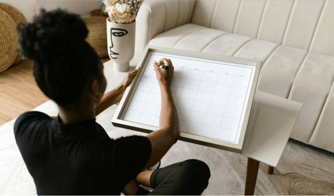 A person writing on a board