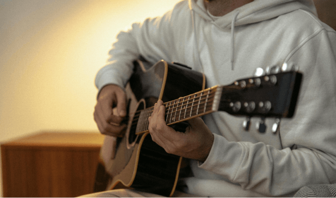 A person playing on a guitar