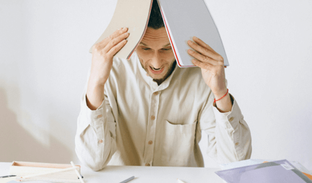 Stressed person holding a notebook