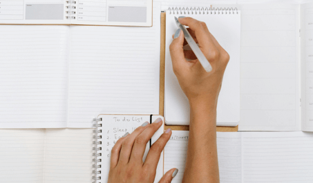 Person writing on a notebook
